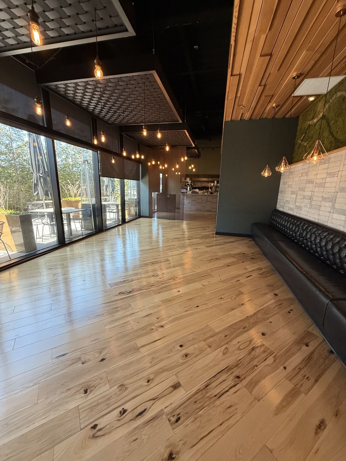 Light varied-tone wood floor in an interior with banquette seating