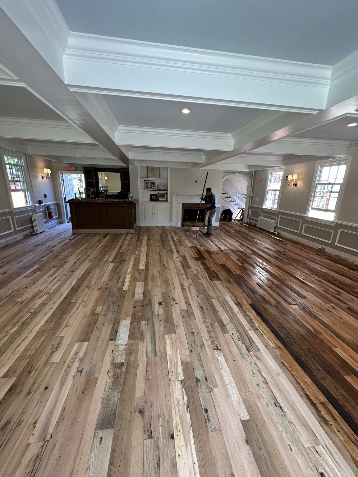 Wood floor with varied board tones, photographed during on-site work