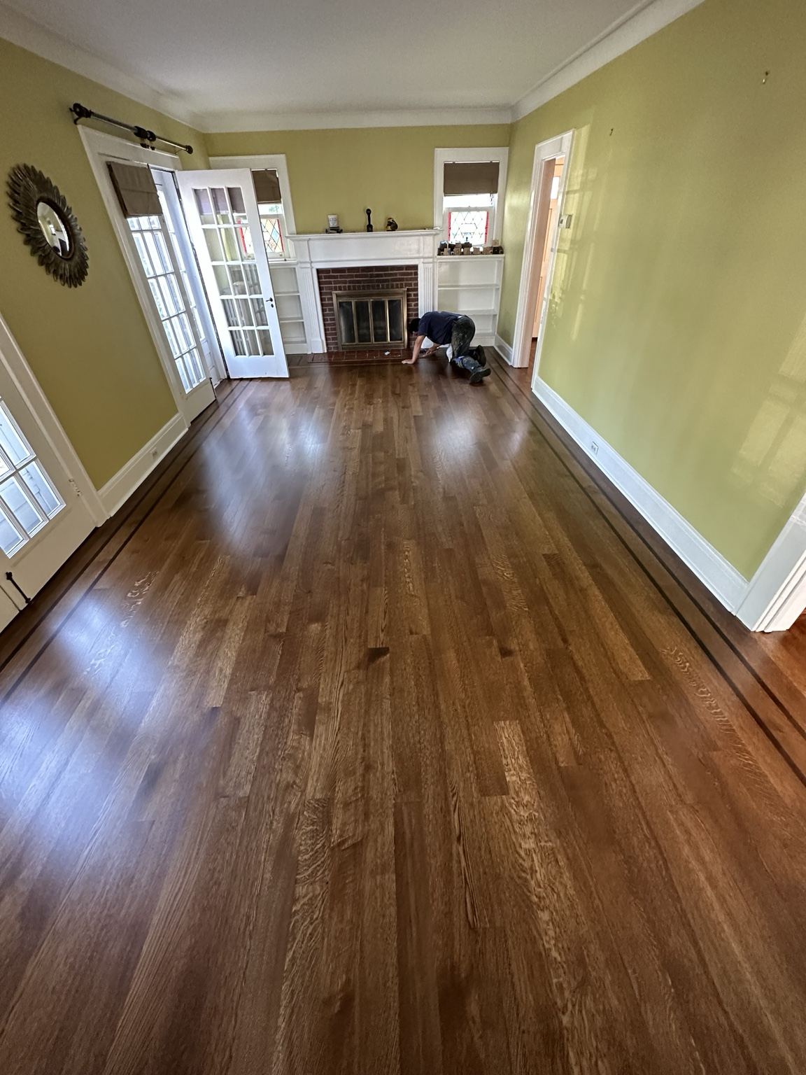 Warm-toned strip wood floor in a room with a fireplace