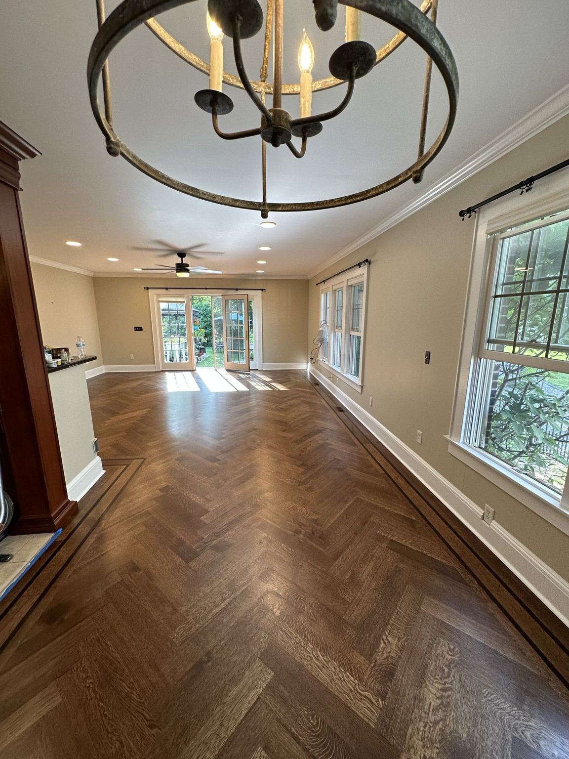 Herringbone floor stained a warm brown, border and walnut strips visible