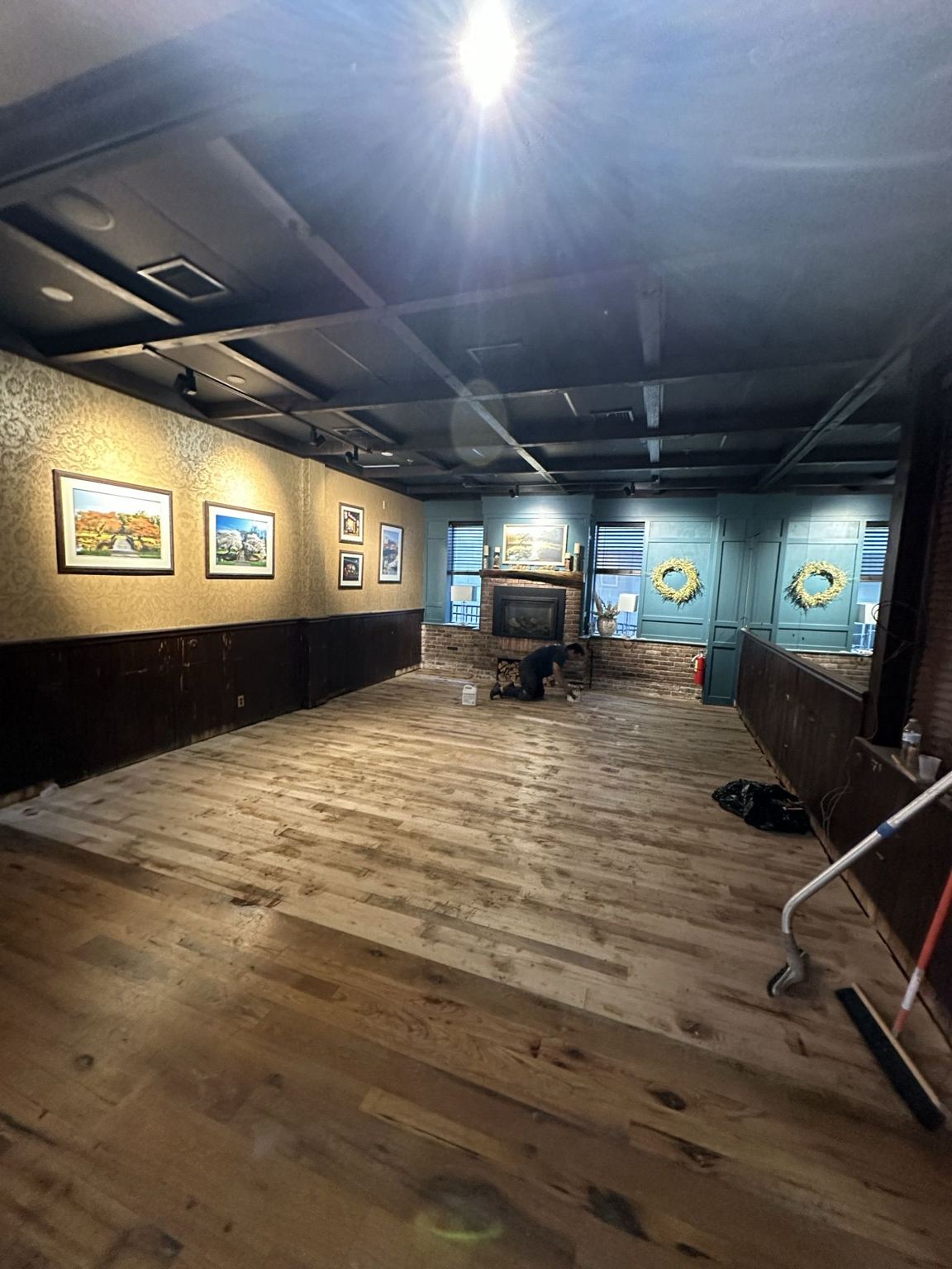 Stain and finish being applied across the new floor